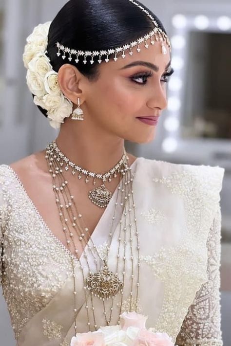 Find the best bridal makeup artists in your budget & desired city with contact information, portfolio & trusted reviews at Weddingbazaar - Trusted Wedding Services for Every Indian Wedding! #southindianwedding #southindianbride #southindianbridemakeup #southindianbridemakeuplook #southindianbridemakeover South Indian White Sari Look, White Saree Jewellery Ideas, Jewellery On White Saree, Sri Lanka Wedding Dress, Bridal Kandyan Saree, Bridal Saree Sri Lankan, White Sarees For Wedding, Sri Lankan Bridal Saree, Sri Lankan Jewelry