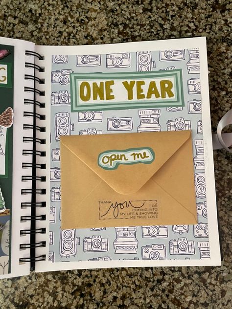 Theres a letter in the envelope #scrapbooking Scrapbook Design Ideas For Boyfriend, Spiral Scrapbook Ideas, Scrapbook With Letters, Memory Book First Page, 1year Anniversary Boyfriend Scrapbook, Envelope Scrapbook Ideas, Dad Scrapbook Ideas, One Year Scrapbook Page Ideas, A Year Of Us Scrapbook