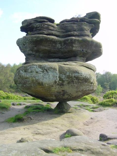 This balancing rock formation is one of the Brimham rocks, located on Brimham Moor in North Yorkshire, England. Made of millstone grit, it was carved over time through water and wind erosion. The bottom layer eroded fastest. Brimham Rocks, Halong Bay, Natural Rock, Rock Formations, Natural Phenomena, Alam Yang Indah, Land Art, A Rock, Amazing Nature