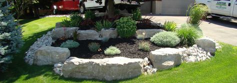 Beautifully landscaped garden with Armour stone and black mulch. Black Rock Landscaping, Landscaped Garden, Walkway Landscaping, Stone Landscaping, Landscaping Retaining Walls, Professional Landscaping, Front Landscaping, Landscape Plans, Home Landscaping