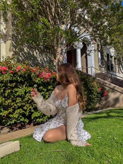 Girl with brown hair and a flower white dress and a cardigan, sitting on the grass in front of a flower bush Alaina Core, Lilly + Core + Aesthetic, Alina Core, Alyssa Core Aesthetic, Cottage Core Dress, Aesthetic Cottagecore, Princess Core, Soft Girl Aesthetic, Afternoon Dress