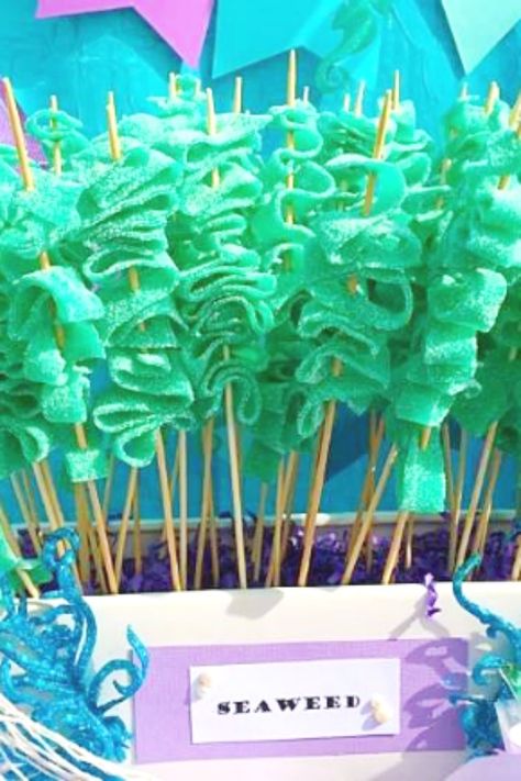 Another easy mermaid party food is candy seaweed make of Shock Tongues. All you need to do is fold them back and forth on a skewer and you're good to go. They literally are that easy to do! See more party ideas and share yours at CatchMyParty.com #catchmyparty #partyideas #mermaidparty #mermaids #mermaidpartyfood #undertheseapartyfood #mermaidcandy #seaweed Easy Mermaid Party, Mermaid Party Food Ideas, Superhero Training, Mermaid Birthday Party Food, Mermaid Party Food, 4de Verjaardag, Ariel Birthday Party, Ocean Birthday Party, Mermaid Birthday Party Decorations