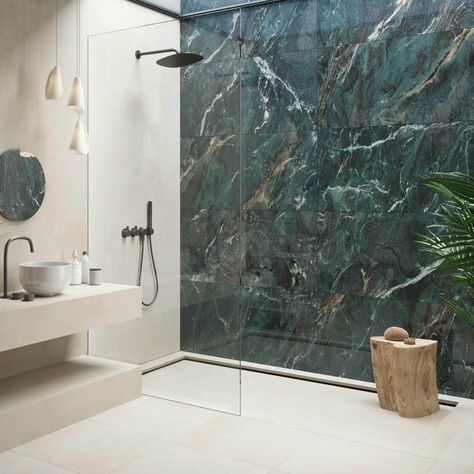 Discover the elegance of the Deluxe Green tile, a bold statement in luxury with its striking dark green marble effect and detailed, multi-tonal veining that adorns its highly polished, porcelain build. Perfect for creating an opulent atmosphere on interior walls and floors, these large format 1200x600mm tiles, with a 10. 5mm thickness, promise durability and timeless beauty. Tiled Floor And Wall Bathroom, Onyx Tile Bathroom Wall, Green Porcelain Tile Bathroom, Feature Shower Wall Tiles, Bathroom With Dark Green Tiles, Green Marble Tiles Bathroom, Large Green Tile Bathroom, Bathroom Ideas Green And Gold, Marble Feature Wall Bathroom