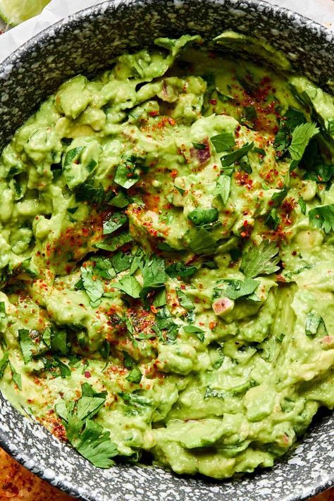 Inspired by my restaurant days, this easy Fresh Guacamole recipe combines not 1 but 2 ripe avocados with jalapeños, red onion, fresh lime juice, and lots of cilantro. Smashed together in a zip-top bag (or molcajete!) with my secret ingredient –Tajín! – the result is a chunky-creamy guacamole dip with bright, tangy, and spicy flavor. Ready in 15 minutes or less and with all the citrus, this homemade guacamole never browns! #guacamole #guacamolerecipe #guacamoledip #avocadorecipes #mexicanfood Guacamole Recipe No Cilantro, Fresh Guacamole Recipe, Guacamole Dip Recipes, Creamy Guacamole, Homemade Guacamole Recipe, Guacamole Ingredients, Spicy Guacamole, Guacamole Recipe Easy, Chunky Guacamole