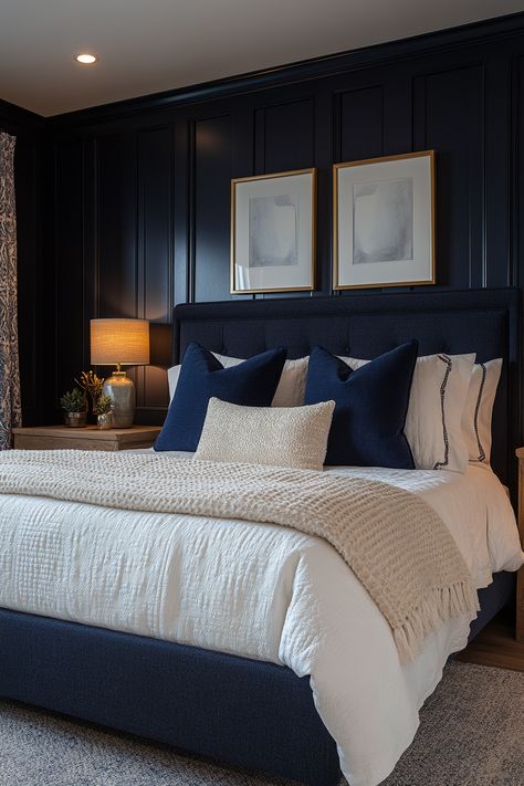 Create a cozy and chic navy blue and gold bedroom with these 29 stunning ideas.  Explore the versatility of this color combination to create a space that feels both inviting and luxurious.  Discover stunning decor ideas like navy velvet headboards, gold-framed mirrors, and brass light fixtures.  Add navy and gold throw pillows, gold geometric wall art, and plush navy carpets for a cozy and stylish bedroom oasis. Navy Spare Bedroom, Midnight Blue Room Decor, Navy Wall Bedroom Decor, Blue And Brass Bedroom, Navy Blue Wall Paneling Bedroom, Navy Bed Decor, Bedroom Navy Headboard, Dark Navy Master Bedrooms Decor, Bedrooms With Navy Accent Wall