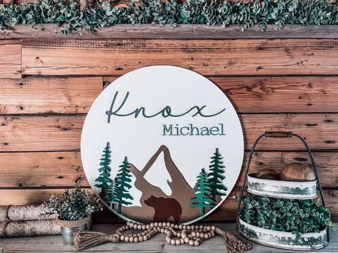 "CHRISTMAS ORDER DEADLINE - NOVEMBER 30TH. Anything ordered after November 30th will not be shipped until the new year! For all the rough and tough little boys out there I have the perfect round sign for their nursery or bedroom with laser cut letters. Your little boy will love this round circle sign in their room, highlighting their first and middle name. Pick their favorite colors for background, first name and middle name to perfectly pair this sign with your decor. A fun and unique addition and the perfect gift for a baby shower, new baby or for your very own bundle of joy! Details of this sign: *Handmade from maple wood. *Lovingly distressed, sanded, and varnished for protection. *Approximately 24\" tall, 24\" wide, and total 1\" thick. *Includes a sawtooth hanger on the back for easy Colors For Background, Nursery 2024, Wildlife Nursery, Notes Letters, Nature Nursery, Forest Bedroom, Nursery Diy, Towel Ideas, Baby Door Hangers