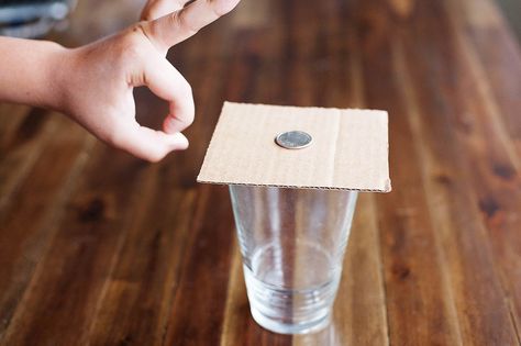 Here’s a simple (but fun) trick for the kids! You only need coin(s), a cup and a piece of cardboard. Place the cardboard on top of the cup. Place a coin in the center of the cardboard. Give the cardboard a quick, fairly hard flick. Watch the coins fall down into the glass while the...Read More » Learn Magic Tricks, Coin Crafts, Coin Tricks, Magic Tricks For Kids, Laws Of Motion, Experiments Kids, Easy Magic Tricks, Easy Magic, Travel Movies