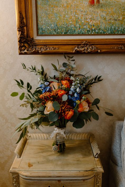 Blue And Rust Wedding Bouquet, Wedding Bouquets Blue And Orange, White Orange Blue Wedding Bouquet, Blue Fall Wedding Bouquets, Fall Blue Bouquet, Terracotta And Blue Bouquet, Simple Colorful Floral Centerpieces, Blue Fall Flower Arrangements, Fall Wedding Flowers With Blue