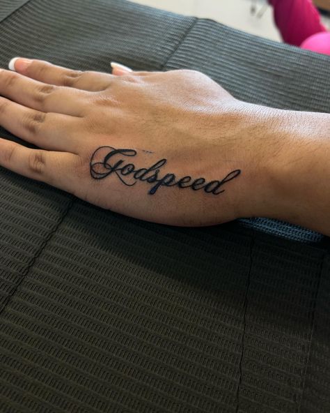 Godspeed🪽 • DM TO BOOK, BOOKING FOR JULY DEALS DROPPING SOON! #ladysmokeinkk #godspeed #firsttattoo #handtattoo #small #cute #girltattoos #girlythings #tatinspo #chopinscript #dmtobook #blackink #dynamicink #ambitionrotary #chicago #midway #girlswhotattoo #explorepage #foryoupage Fancy Writing Tattoo, Godspeed Tattoo On Neck, Godspeed Tattoo Stencil, Godspeed Neck Tattoo, Godspeed Tattoo Font Design, Small Baddie Tats Hand, Godspeed Hand Tattoo, Cutesy Tattoos, Godspeed Tattoo