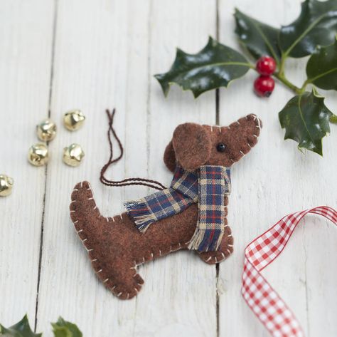 dachshund christmas decoration by the christmas home | notonthehighstreet.com Felt Dog Bone Ornaments, Dog Felt Ornaments, Sewing Christmas Decorations, Diy Felt Christmas Ornaments, Felt Crafts Christmas, Astuces Diy, Felt Christmas Decorations, Dachshund Christmas, Christmas Ornaments Homemade