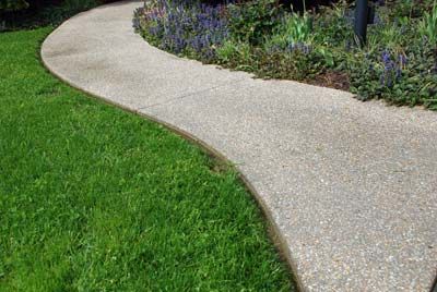 exposed aggregate concrete walkway Front Yard Walkway, Exposed Aggregate Concrete, Aggregate Concrete, Courtyard Landscaping, Exposed Aggregate, Pathway Landscaping, Concrete Walkway, Front Walkway, Concrete Paving