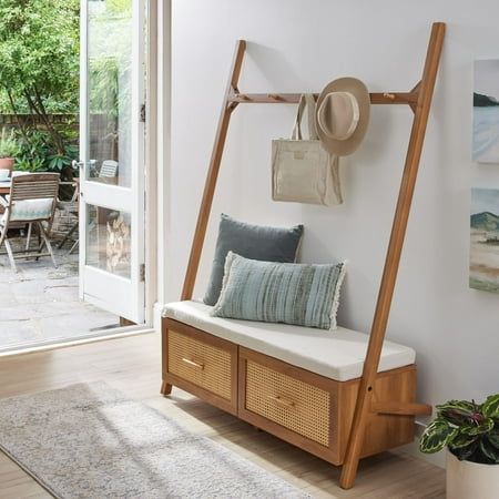 Streamline your entryway with the Better Homes & Gardens Springwood Entryway Tree. Crafted from laminated particleboard, this bench exudes a trendy vibe with its charming woodgrain finish and rattan drawer fronts. Utilize the five chunky wood knobs for hanging coats, scarves, and bags, while the two deep drawers effortlessly organize shoes and accessories. The leaning ladder design, coupled with minimalistic features and an open back, enhances the overall aesthetic. Take a seat on the padded bench while slipping on your shoes. For added stability, the entryway hall tree includes a wall anchoring kit. Delivered flat to your door, assembly is required upon arrival, and we recommend the hands of two adults for the task. Assembled dimensions: 68.7"H x 54"W x 18.34"D. Color: Black. Ikea Hall Tree Entryway, Entryway Bench And Storage, Coat Rack Bedroom Aesthetic, Modern Entryway Furniture, Mail Station Entryway, Mid Century Modern Hall Tree, Entryway Tree Bench, Eclectic Entryway Table, Shoe Rack Decor Entryway