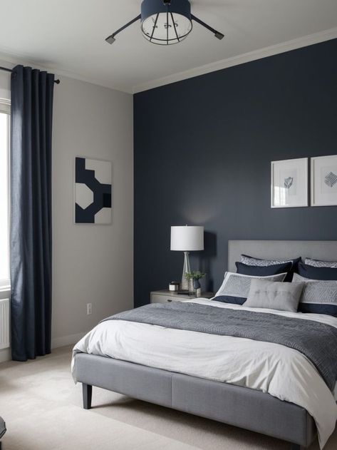 Create a stylish and sophisticated boys bedroom with a combination of grey and navy. Use a navy blue accent wall as a focal point, complemented by grey bedding and curtains for a modern and masculine look. Complete the design with industrial-style light fixtures and geometric patterns for added visual interest. Blue Teen Bedrooms, Navy Blue Accent Wall, Grey Boys Rooms, Navy Blue Rooms, Blue Accent Wall, Blue Boys Bedroom, Light Gray Bedroom, Navy Inspiration, Blue Gray Bedroom