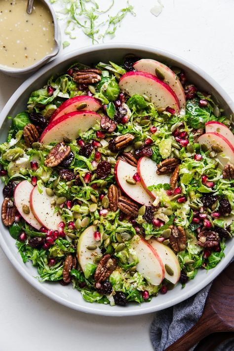 Shaved Brussels sprouts make an elegant, refreshing fall salad when dressed with a simple, creamy maple vinaigrette dressing and tossed with crisp apple slices. Couscous, Salad Fall, Shaved Brussel Sprout Salad, Maple Dressing, Healthy Dinner Salads, Maple Vinaigrette, Brussels Sprout Salad, Autumn Salad Recipes, Fall Salad