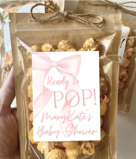 "Your guests are sure to love these adorable stand-up customized popcorn bags! The bags come with a custom label and bow already attached--when your bags arrive, simply stuff with your favorite popcorn and pass out for all your guests to enjoy! Feel free to message me if you have any custom design requests.  PRODUCT DETAILS:  🌼Custom label and zip bag and bow 🌸Personalized 4\"x3\" glossy waterproof white labels  🌼Standing zip pouches measure 7.8 inches tall x 5.5 inches wide 🌸Resealable zip pouches with clear front and kraft brown back  🌼Holds approximately 1-2 cups of popped popcorn 🍿  🚨POPCORN IS NOT INCLUDED!🚨The product is pictured with DIY candied popcorn (popcorn, sugar, butter, food coloring) or store bought gourmet, but this listing is for CUSTOM BAGS ONLY!  I will message Bows And Pearls Baby Shower Theme, Graduation Dinner Party, She Did It Graduation, Candied Popcorn, Popcorn Baby Shower Favors, Pearl Baby Shower, Baby Shower Snacks, Pink Party Favors, Pink Popcorn