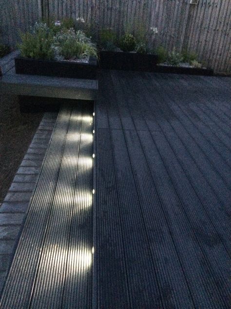 Funky led garden lights. Composite decking in dark grey. Black Decking Ideas Garden, Black Garden Decking, Dark Grey Decking Ideas, Dark Decking Ideas, Dark Grey Decking, Black Composite Decking, Dark Grey Deck, Black Decking Ideas, Grey Composite Decking