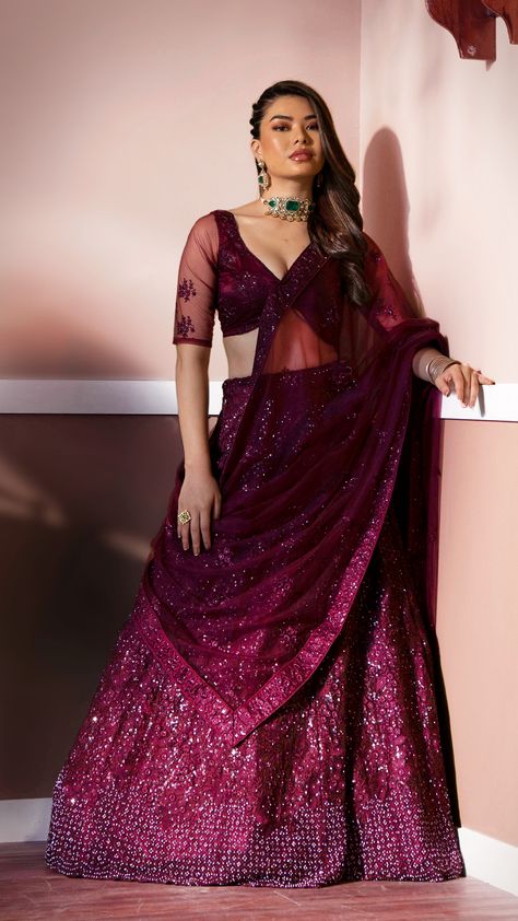 Our wine luxurious embroidered lehenga with illuminating metallic sequins that is threaded into scattered patterns. It is a dazzling outfit which is perfect for a contemporary bride like you! Jewellery With Maroon Lehenga, Wine Lehenga Jewellery Ideas Simple, Wine Lehenga Party Wear, Jewellery With Wine Colour Lehenga, Wine Color Dress Makeup, Wine Colour Lehenga Color Combos, Reception Lehenga For Bride Sister, Maroon Colour Lehenga, Sequin Lengha