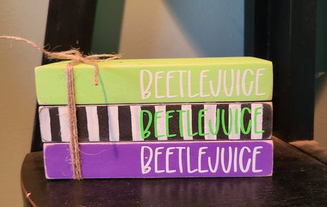 "This Beetlejuice decor will be. Great addition to your Halloween decor! It's great on a tiered tray or any spot around the home. The wood books are painted and have permanent vinyl. They have been distressed for a rustic look and are tied together with jute twine. They measure 6x4\"." Beetlejuice Room, Beetlejuice Decor, Beetlejuice Book, Beetlejuice Halloween, Movie Decor, Home Decor Wood, Wood Book, Book Stack, Mini Book