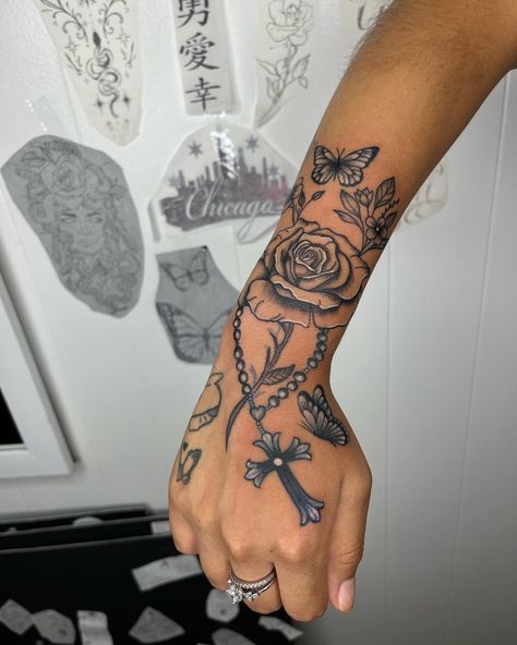 dm to set up your next appointment 🌹 #ladysmokeink #dynamiccolor #blackink #tripleblack #black #rose #rosary #butterflies #girlytattoos #handtattoos #armtattoos #girlswithtattoos #girlswhotattoo #tatinspo #dmtobook #chicago #midway #garfieldridgechicago Rosary Hand Tattoo, Rosary Tattoos, Rosary Rose Tattoo, Rose And Rosary Tattoo Design, Rosary And Rose Tattoo, Rosary With Roses Tattoo, Roses With Rosary Tattoo Half Sleeves, Rose Butterfly Rosary Tattoo, Rosary Tattoo On Hand