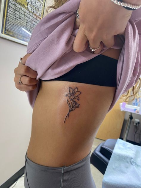 Patchwork, Tiny Lily Flower Tattoo, Lily Flower Rib Tattoo, Lillies Tattoo Designs, Lilly Name Tattoo, Daylillies Tattoos, Tattoo Of Lily Flower, Lower Side Stomach Tattoos Women, May Lily Tattoo