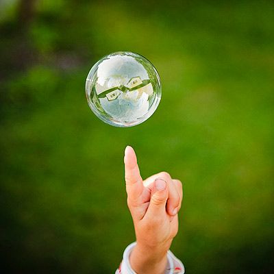 Add 1 cup of dishwashing soap to a gallon of warm water. An extra two to three tablespoons of glycerin, is the secret to super-big bubbles. Pour your concoction into a flat, rimmed tray, like a sheet-cake pan. Make a wand by bending a wire hanger into a loop. Teach your toddler to lift the wand slowly and walk backward to let loose a gigantic bubble. You can experiment with making different kinds of wands with straws, pipe cleaners, even fly swatters. Diy Bubbles, Preschool Outdoor Activities, Bubble Making, Big Green Monster, Bubble Play, Fly Swatters, Outdoor Activities For Toddlers, Bubble Solution, Outside Fun