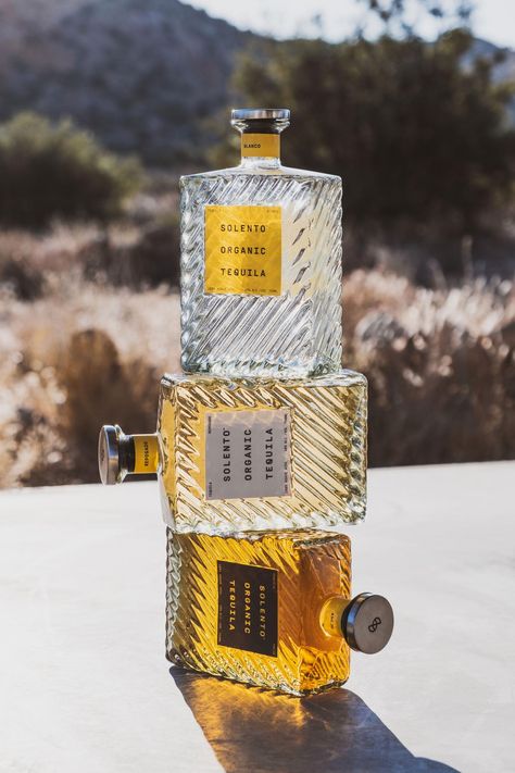 Solento tequila glass bottles stacked on top of one another Mezcal Brands, Sipping Tequila, Photography Mockup, Bottle Design Packaging, Lemon Blossoms, Modern Packaging, Reposado Tequila, Tequila Bottles, Sweet Coffee