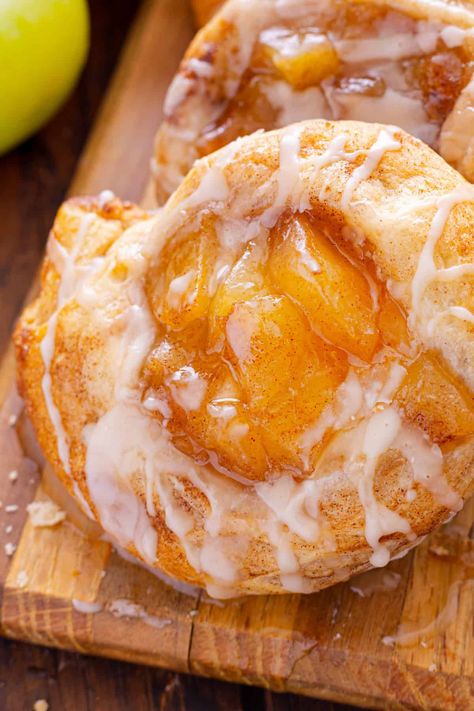 This Apple Danish recipe offers two options for making danishes - with crescent rolls or puff pastry with cream cheese. Both result in an irresistible dessert with apple pie filling and a sweet glaze on top. Easy Apple Danish Recipe, Caramel Apple Danish, Apple And Cream Cheese Danish, Apple Breakfast Pastries, Apple Pillsbury Crescent, Pineapple Danish Recipe, Apple Pie Danish Recipe, Crescent Roll Recipes Apple, Apple Cream Cheese Puff Pastry