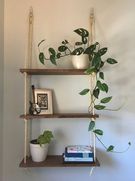 Handmade wooden and rope hanging shelves, perfect for showcasing your favorite items, while utilizing valuable wall space...and in our case, keeping plants away from our cats. This versatile piece adds a beautiful rustic/nautical touch to any room! Great for: -Bedrooms, to display photos and keepsakes -Bathroom to hold towels, tissue paper and toiletries  -Living room or office, for books and beautiful plants  -Kitchen for coffee mugs, spices and cook books Shelves are made with pine, and natural sisal rope. Each piece is made to order, so there may be slight variances. The shelving unit pictured is English Chestnut, but we offer various other options. When placing your order, please make note of which finish you would like in the notes. We also do take custom orders! If you would like to Hanging Rope Shelves, Wooden Planter Boxes, Rope Shelves, Wooden Drawers, Three Tier, Hanging Rope, Hanging Shelves, Room Ideas Bedroom, Wooden Shelves