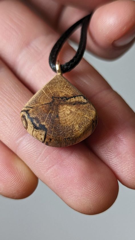 This is a handcrafted wooden pendant made from locally sourced and naturally fallen wood. This pendant features a beautiful and unique pattern caused by the natural decay of wood, as well as a hand sculpted design to complement it. The result is a timeless, breathtaking and organic piece of jewelry that suits women, men and children for almost any occasion or simply everyday life. I make these using only naturally fallen wood that I find on walks through my local forests - occasionally in the co Carved Wooden Pendant, Wood And Stone Jewelry, Wood Pendant Necklace, Manly Necklace, Wood Necklace Pendant, Handmade Wooden Jewelry, Wood Jewelry Diy, Wood Forest, Wood Jewelery