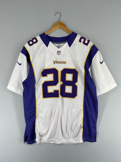 REMINDERTHIS IS USED CLOTHING PLEASE DO NOT EXPECTED IT LIKE TO BE NEW OR IN PRISTINE CONDITION Feel free to contact me for any questionI'll assist you with my pleasureVintage Minnesota VIKINGS Nfl Jersey Xlarge 1990s Nfl American Football Rugby Team Sportswear Andrian Peterson Fan Apparel Jersey Size XL *All measurements are taken with the garment flat on the groundSIZE ON TAGNone but fits like Size XL ACTUAL SIZE MEASUREMENTARM PIT TO ARM PIT25.5inches BACK COLLAR TO HEM32.5inches CONDITIONGR Rugby T Shirts Design, Cool Jersey Design Football, Vintage Nfl Shirts, American Football Jersey Design, Vintage Football Jersey Outfit, Nfl Jersey Outfit, Football Jersey Design, American Football Shirt, Adrian Peterson