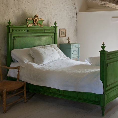 This bed is in Annie Sloan's house in Normandy, France and is painted with Chalk Paint® in Antibes Green and is gilded with Brass Leaf on the central classical laurel leaves and shield on the bedhead. It is finished with Dark Chalk Paint® Wax to bring out the texture in the wood and give the Brass Leaf a sense of faded grandeur. Euro Farmhouse, Antibes Green, Green Painted Furniture, Euro Trash, Beautiful Bedroom Designs, Painted Beds, Wingback Chairs, Rustic Inspiration, Painting Wood Furniture