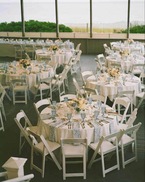 Round guest tables with paisley light blue napkins, blue water goblets and beautiful floral compote centerpieces Blue Water Goblets Wedding, Blue Goblets Table Setting, Compote Centerpiece Wedding, Floral Compote, Goblets Wedding, Blue Water Goblets, Blue Goblets, Blue Table Settings, Wedding Goblets