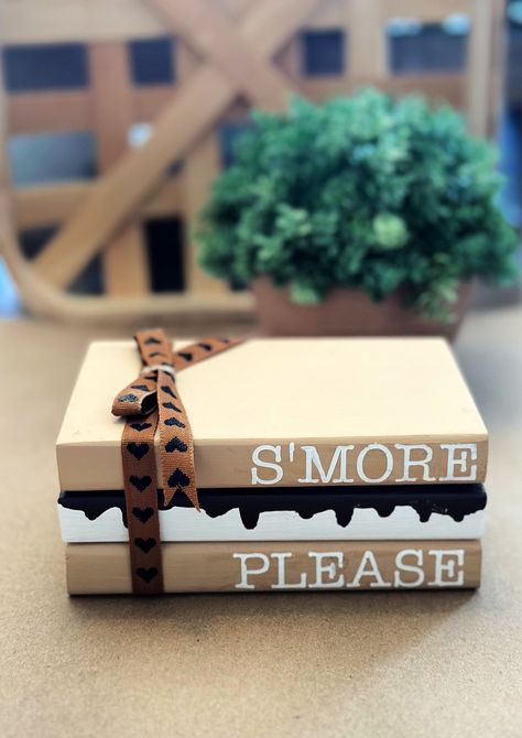 "S'more Please wooden book stack. This adorable farmhouse book stack is perfect for your summer tiered tray decor.  Book stack measures approximately 5\" x 3\" x 3\" and are painted with ribbon added. Blocks are glued together. IMPORTANT NOTICES: By submitting your order, you agree to all shop policies, thank you! I use a third party app to make the QR codes. I am not responsible if there site is down. I will have your message stored indefinitely and it will work again as soon as their site is back up and running! 1. Our processing time varies seasonally, you can see our current processing time by checking the \"shipping & policies\" tab located in this listing, Please be aware that processing time does not including shipping time, so please add 3-5 business days on top of processing time. Stacked Wooden Books Diy, Book Stack Decor Diy, Wooden Book Decor, Halloween Stacked Books, Dollar Tree Tiered Tray Diy, Diy Book Stacks, Fall Book Stacks, Summer Crafts To Sell, Wooden Stacked Books