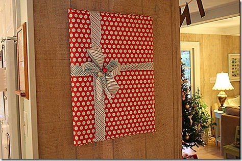 Christmas Decor Ideas Wrapping Paper, Wrapping Paper Pictures Wall Art, Present Wall Decor Christmas, Wrapped Wall Art For Christmas, Picture Wrapped As A Present On Wall, Wrapping Paper On Walls Christmas, Wrap Pictures On Wall Christmas, Christmas Wrapped Pictures On Wall, Decorating With Wrapping Paper