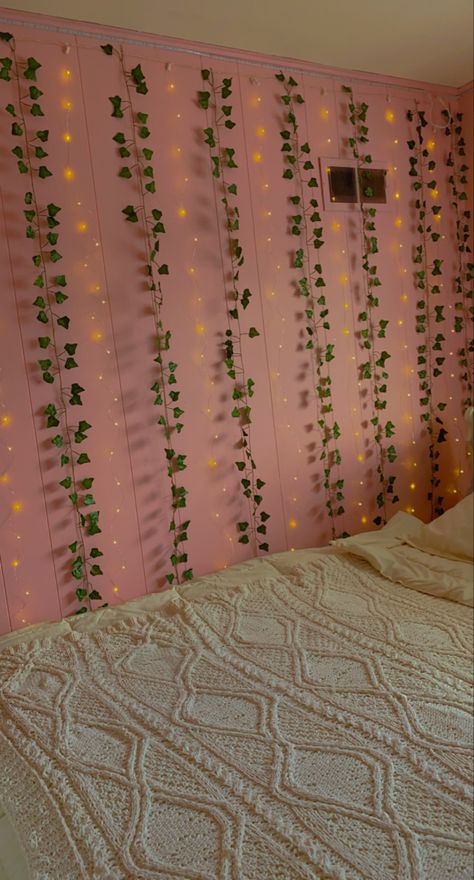 pink walls of bedroom with ivy vines and curtain fairy lights alternating with white bed comforters Pink Room With Vines, Pink Wall Curtain Ideas, Pink Walls Aesthetic, Bedroom With Pink Walls, Aesthetic Teen Bedroom, Aesthetic Vines, Bedroom Ivy, Curtain Fairy Lights, Light Pink Bedrooms