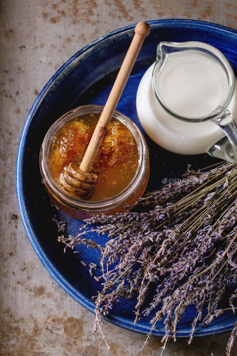 Honey, milk and lavender by NatashaBreen. Open glass jar of liquid honey with honeycomb and honey dipper inside, glass jug of milk and bunch of dry lavender in...#Open, #glass, #jar, #NatashaBreen Milk And Honey Aesthetic, Honey Pictures, Honey And Milk, Dry Lavender, Honey Art, Honey Milk, Honey Photography, Honey Water, Honey Packaging