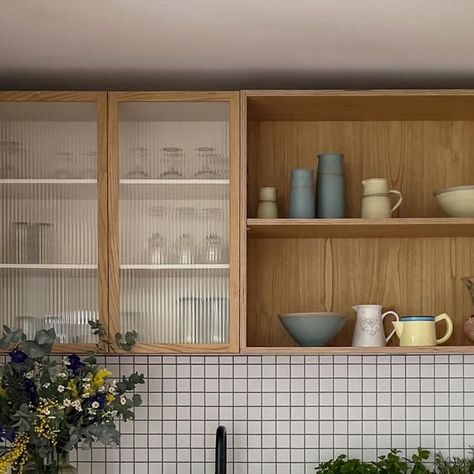 PLUCK Kitchens on Instagram: "Set in a 1950s cottage perched on the edge of a protected forest in Wiltshire, this compact PLUCK kitchen has some clever design details meaning it includes plenty of storage despite its small footprint, and importantly doesn’t feel overwhelmed by cupboards! Look closely and you’ll see one side of the room has slightly shallower lower cupboards, wall storage includes shelves and fluted glass cabinets, both a lighter alternative to solid doored cabinets. A Prep Table provides a handy central worktop spot, being able to see through the legs of this piece of furniture another trick for keeping the space feeling more open. ⁠
The palette is soft and natural – Brockwell Moss, Eccles and Sweet Chestnut wood...so soothing⁠" Soft Kitchen Design, Shallow Kitchen Cabinet Wall, Pluck Kitchen, Glass Cupboards Kitchen, Mismatched Cabinets, Fluted Glass Kitchen, Fluted Glass Cabinet, Kitchen Glass Cabinets, 1950s Cottage