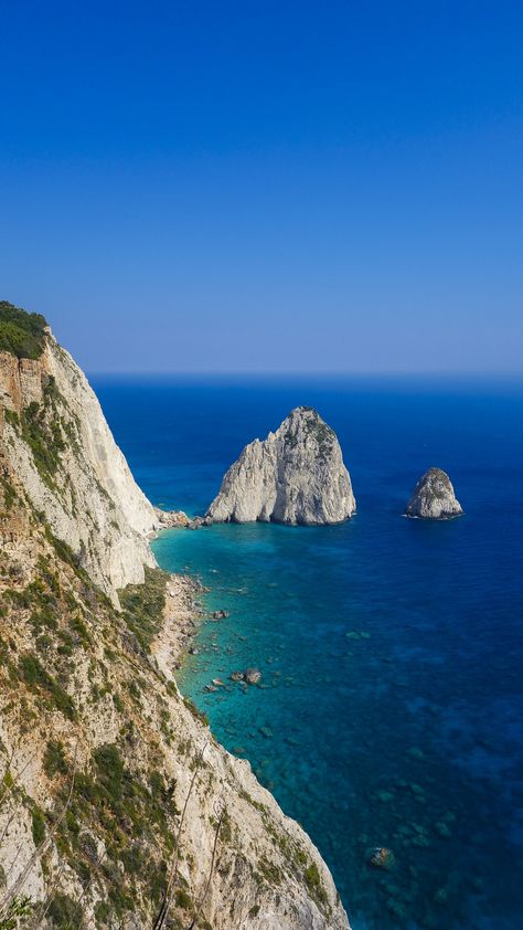 The Mizithra - two pyramid-shaped white rocks. They got their name from a local white feta cheese called Mizithra which is produced in Zakynthos. Individually the rocks are named Megali Mizithra ("large white cheese") and Mikri Mizithra ("small white cheese") Greece Sea, Paris Travel Photography, Zakynthos Greece, Places In Greece, Rhodes Greece, Travel Inspiration Destinations, Travel Photography Inspiration, Island Getaway, Europe Travel Destinations