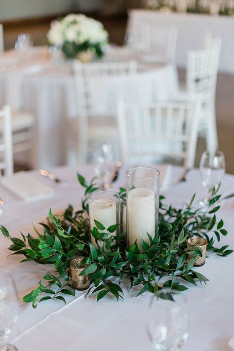 Morning Wedding Reception Decoration, Greenery Tablescape Round Table, Round Table With Greenery, Round Greenery Centerpiece, Greek Centerpieces Table Decorations, Greens And Candles Centerpieces, Candle Table Arrangements, Greenery Ring Centerpiece, White And Greenery Wedding Centerpieces Round Table