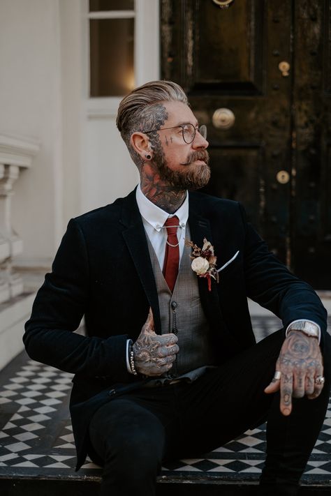 Tattooed Groom in Smart Suit and Glasses Men’s Alternative Wedding Suit, Menswear Wedding Casual, October Wedding Suits Men, Groom Suit Vest, Vintage Tuxedo Wedding, Men Black Wedding Suit, Groom Suit Alternative, Tattooed Man In Suit, Alternative Groom Outfit