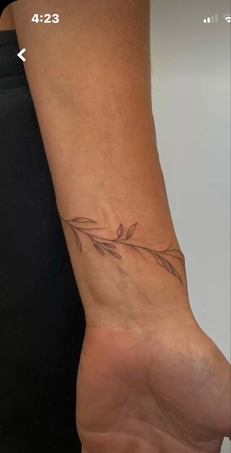 Simplistic Floral Tattoo, Rose Tattoo Wrapped Around Arm, Roman Numeral Tattoo With Vines, Fine Line Vine Tattoo Arm, Dainty Vine Tattoos For Women, Dainty Botanical Tattoo, Vine Fine Line Tattoo, Arm Dainty Tattoo, Olive Branch Wrap Around Tattoo