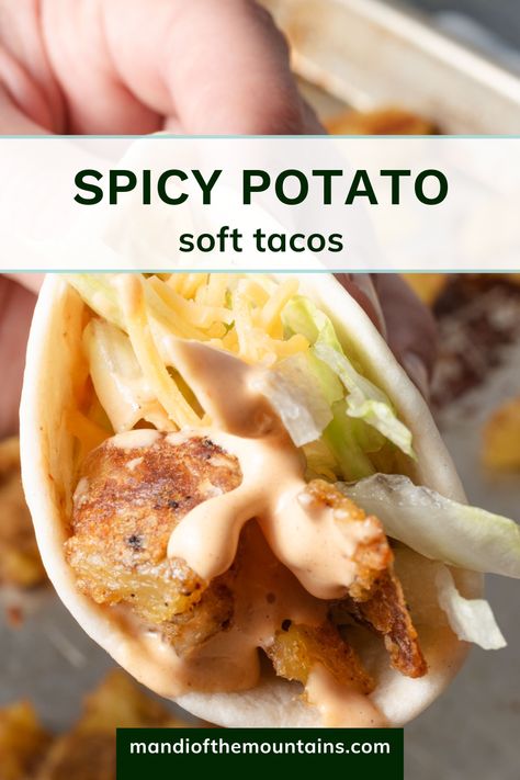 Closeup of a potato taco with creamy chipotle sauce, lettuce, and cheese. Taco Bell Spicy Potato Taco Sauce, Spicy Potato Soft Taco Taco Bell, Taco Johns Potato Ole Seasoning, Taco Bell Potato Soft Taco, Taco Bell Spicy Potato Taco, Potato Soft Tacos, Spicy Potato Tacos, Rolled Cabbage, Taco Bell Potatoes