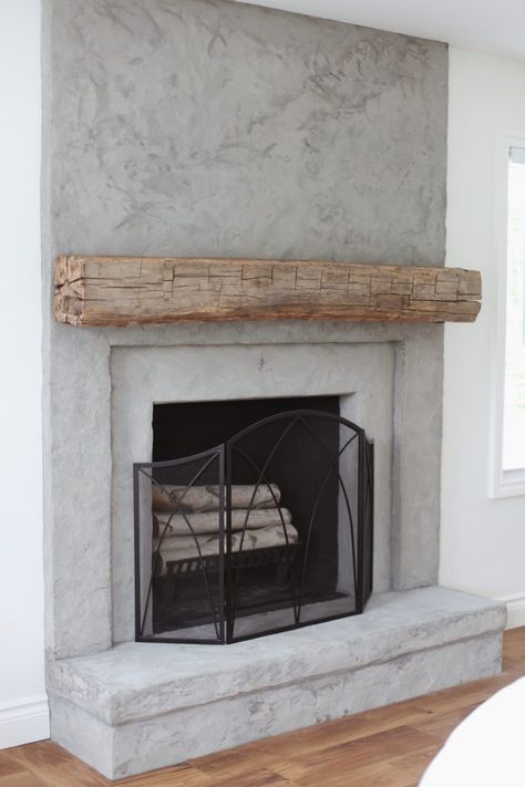 concrete fireplace with reclaimed wood mantel Concrete Fireplace With Hearth, Fireplace Mantel Beam, Stucco Fireplaces Indoor, Real Wood Fireplace Ideas, How To Build An Indoor Wood Burning Fireplace, Wood Frame Fireplace, Natural Fireplace Ideas, Cement Fireplace With Wood Mantel, Stucco Fireplace With Wood Mantel