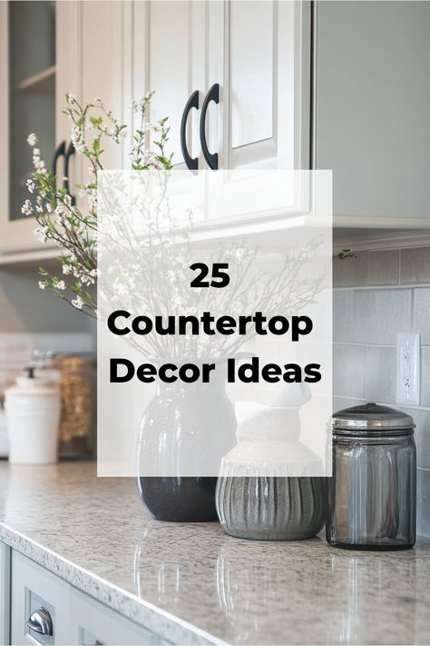 25 Countertop Decor Ideas displayed on a modern kitchen countertop with jars and vases. End Of Kitchen Counter Decor, Small Round Tray Decor Ideas, Simple White Kitchen Decor, White Kitchen Counter Styling, Kitchen Cake Stand Decor, Kitchen Counter Top And Backsplash Ideas, Pretty Kitchen Countertops, Kitchen Counter Top Decor Ideas Modern, Farmhouse Decor Kitchen Countertop