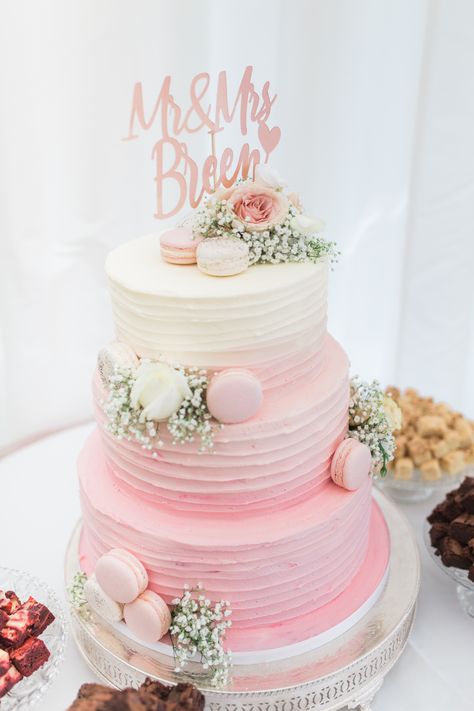 3 tiered cream and pink ombre wedding cake decorated with pink and cream macaroons, roses, gypsophila and a rose gold calligraphy Mr and Mrs cake topper. Pink Cake 3 Tier, Wedding Cake With Macarons, Pink Tiered Cake, Macaroon Wedding Cake, Wedding Cakes Pink, Wedding Cake 3 Tier, Pink Ombre Wedding Cake, 3 Tier Birthday Cake, Wedding Cake Pink