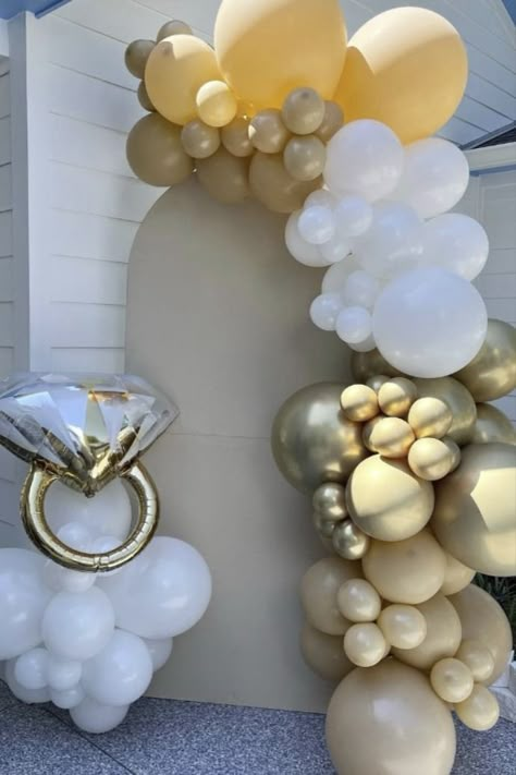 Planning an unforgettable engagement celebration? Elevate your decor with our stunning engagement balloon ring and balloons! Create picture-perfect moments against a rustic wooden backdrop for a romantic atmosphere that's second to none. Dive into the world of Pinterest for more engagement party inspiration! Decorations For Engagements, He Popped The Question Engagement, Engagement Ring Balloon Decor, Engagement Room Decoration, Engagement Party Balloons Decor, Balloon Garland Engagement Party, Engagement Party Background, Small Engagement Party Decorations, Ring In The New Year Engagement Party