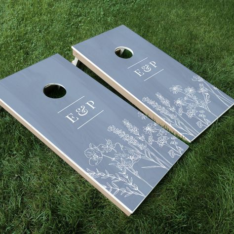 Elegant Wildflower Periwinkle Blue Wedding Cornhole Set - a great way to add fun to an outdoor wedding. A perfect keepsake for the happy couple! Bridgerton Outdoor Wedding, Wedding Inspo Centerpiece Ideas, Sage And Blue Wedding Decor, Wedding Decor Ceremony Outdoor, Fun Outdoor Wedding Ideas, Wedding Outdoor Tables, Diy Wedding Ideas Outdoors, Dusty Blue Table Centerpieces, Dusty Blue Forest Wedding