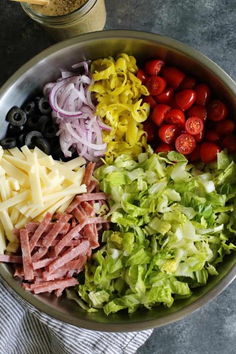 Italian Chopped Salad from afarmgirlsdabbles.com - an Italian salad loaded with fresh goodness, plus salami, provolone, pepperoncini, and olives. It's light, yet hearty, and extra flavorful with a zippy Italian vinaigrette! #salad #italian #chopped #lettuce #tomatoes #onion #salami #provolone #pepperoncini #olives Italian Vinaigrette, Salad Italian, Thanksgiving Fruit, Easter Fruit, Italian Salad Recipes, Italian Chopped Salad, Resep Salad, Salad Pasta, Fruit Salads