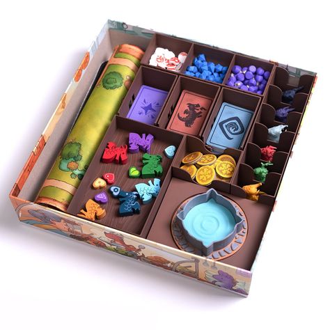 UPDATE: Attention everyone, based on your feedback, we've modified the organizer so it's now fully compatible with card protectors! BoardGeekFox presents: The Flamecraft Organizer! Beyond being a stunning game accessory, it also saves you time. How? - Quick Game Start: No need to sort cards and tokens. Simply take out the organizer components and place them next to the game board. You can get started in just a few minutes! - Unique Design: This isn't just a basic "organizer". Every detail has be Magic Board Game, Unique Board Games, Board Game Organizer, Game Board Design, Board Game Box Design, Board Game Packaging, Card Game Packaging, Boardgame Design, Flamecraft Board Game