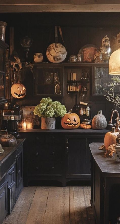 Create a vintage-inspired Halloween kitchen with nostalgic decor. Display retro Halloween postcards on a bulletin board. Arrange a collection of antique candy tins on open shelves. Hang a string of vintage-style Halloween lights above the window. Add charm with a black cat clock on the wall. Place a bowl of old-fashioned candy corn on the counter. This Halloween kitchen decor evokes the warmth and whimsy of Halloweens past while creating a cozy space for modern celebrations. Kitchen Window Halloween Decor, Dark Cottagecore Halloween, Halloween Display Board, Top Of Cabinet Halloween Decor, Vintage Halloween Room, Witchcore Kitchen, Vintage Kitchen Counter Decor, Halloween Counter Decor, Halloween Interior Design